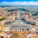 Saint Peter’s Square, featuring 2 fountains and a tall central obelisk, surrounded by columns